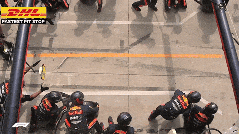 Red Bull Formula 1 pit crew changing four tires during a pit stop